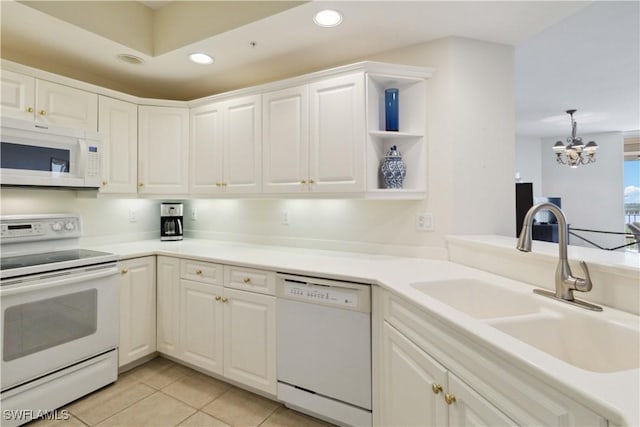 kitchen featuring sink, light tile patterned flooring, white appliances, and white cabinets