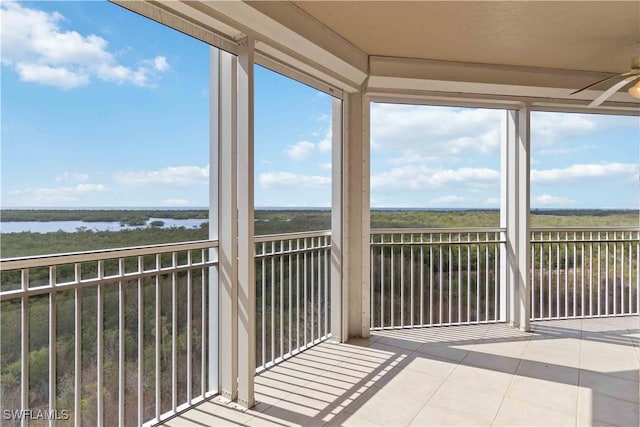 unfurnished sunroom with a water view