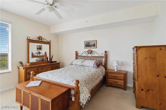 bedroom with multiple windows, light colored carpet, and ceiling fan