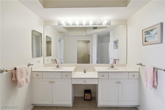 bathroom featuring tile patterned flooring, walk in shower, and vanity