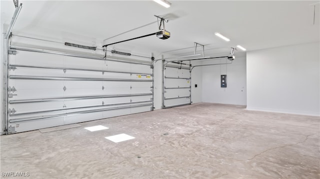 garage with a garage door opener and electric panel