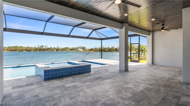 view of patio / terrace with a pool with hot tub, a water view, glass enclosure, and ceiling fan