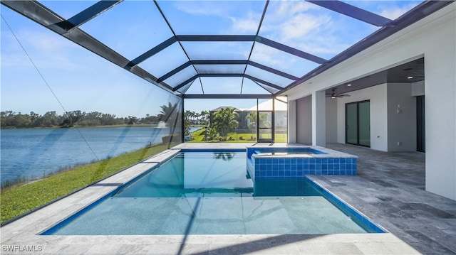 view of pool featuring a patio, glass enclosure, a water view, and ceiling fan