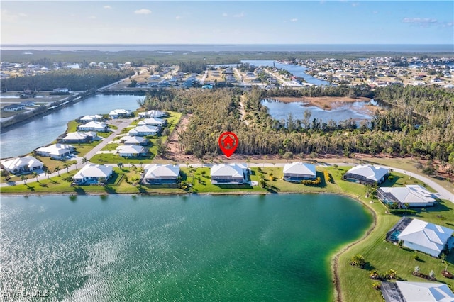 birds eye view of property with a water view