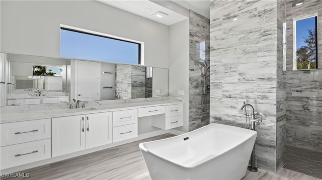 bathroom featuring vanity, hardwood / wood-style floors, and independent shower and bath