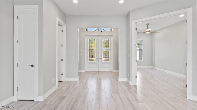 foyer entrance featuring french doors, light wood-type flooring, and ceiling fan