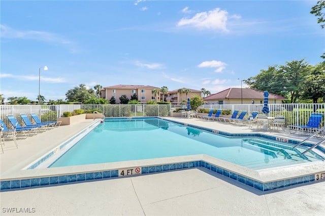 view of swimming pool with a patio area