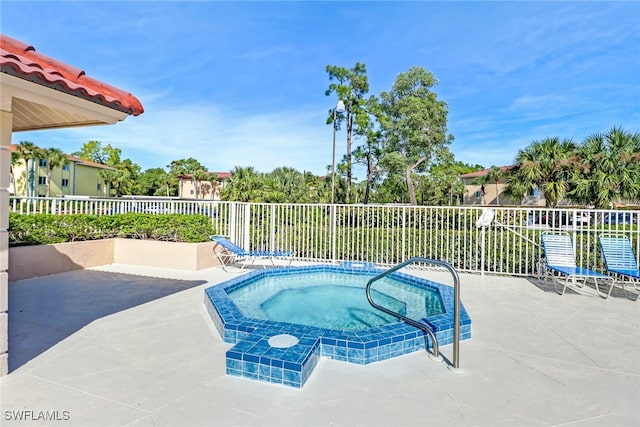 view of swimming pool with an in ground hot tub and a patio area