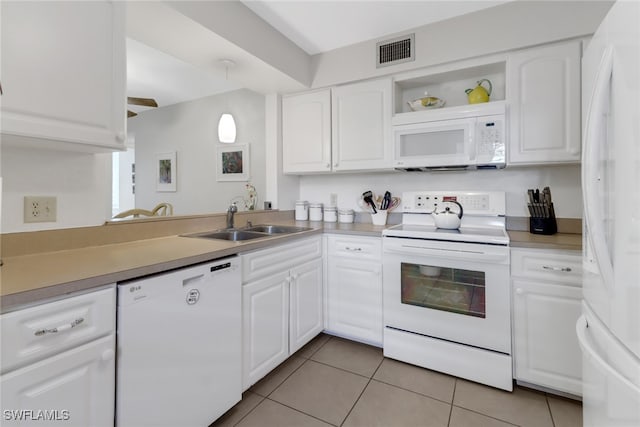 kitchen featuring sink, pendant lighting, light tile patterned floors, white cabinets, and white appliances