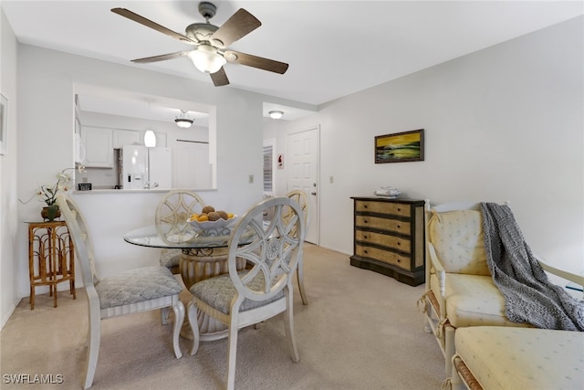 carpeted dining space featuring ceiling fan