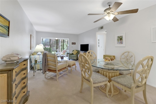 carpeted dining room featuring ceiling fan