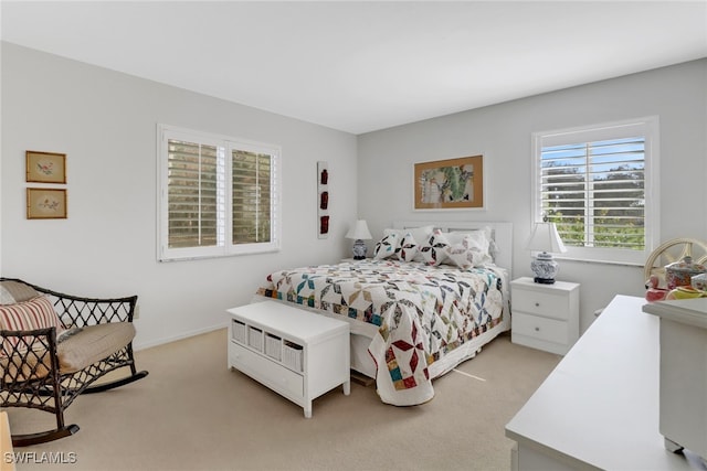 bedroom featuring light carpet