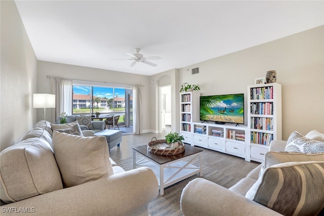 living room with ceiling fan and light hardwood / wood-style flooring