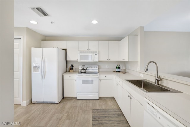 kitchen featuring white appliances, sink, light hardwood / wood-style flooring, and white cabinets