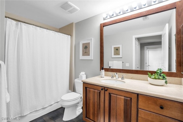 bathroom featuring shower / bath combo, visible vents, vanity, and toilet