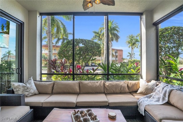 sunroom / solarium featuring a ceiling fan