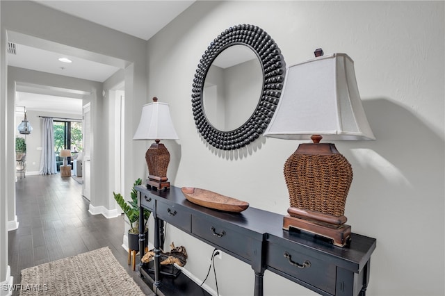 hallway with dark wood-type flooring