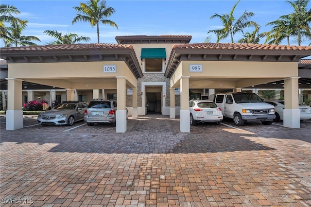 view of building exterior with covered parking