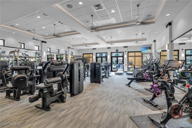 workout area with recessed lighting, carpet, visible vents, and a towering ceiling