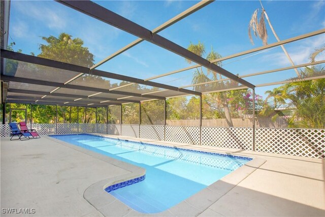 1039 Cardinal St, Naples, FL 34104 - view of pool featuring a fenced in pool, glass enclosure, and a patio