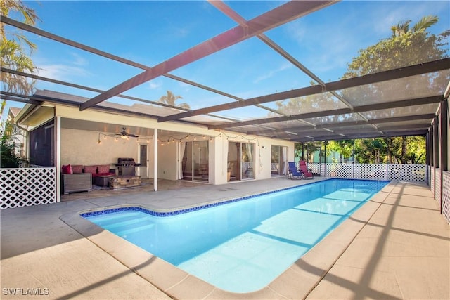 1039 Cardinal St, Naples, FL 34104 - view of swimming pool with glass enclosure, a fenced in pool, a patio, and a ceiling fan