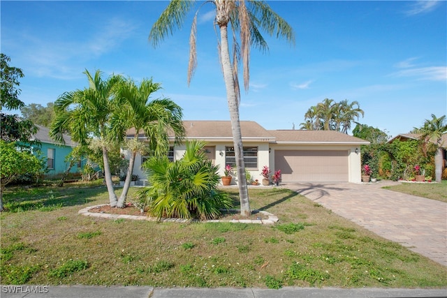 view of front of house featuring a front lawn and a garage