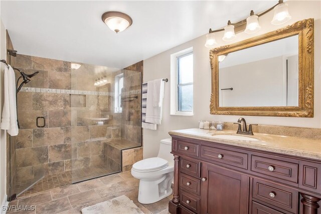 1039 Cardinal St, Naples, FL 34104 - full bath featuring stone finish flooring, vanity, toilet, and tiled shower