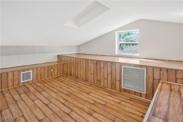 bonus room featuring lofted ceiling and hardwood / wood-style flooring