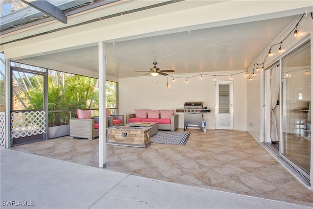 view of patio with ceiling fan and an outdoor living space with a fire pit