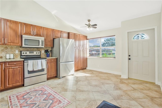 1039 Cardinal St, Naples, FL 34104 - kitchen featuring stainless steel appliances, backsplash, lofted ceiling, ceiling fan, and brown cabinetry