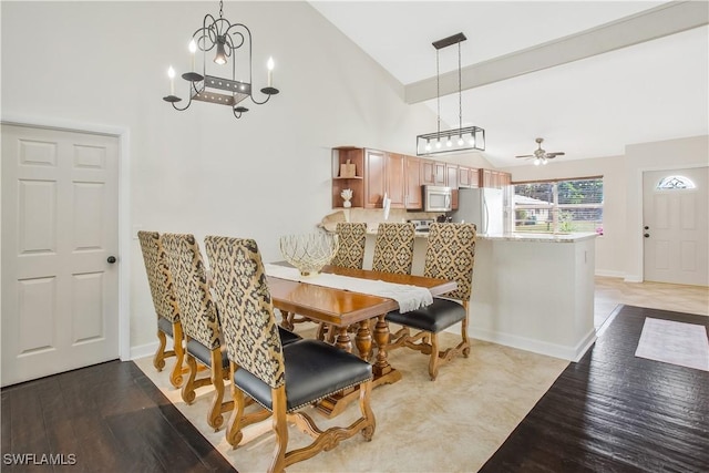 1039 Cardinal St, Naples, FL 34104 - dining room featuring light wood-type flooring, baseboards, high vaulted ceiling, and ceiling fan with notable chandelier