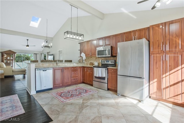 1039 Cardinal St, Naples, FL 34104 - kitchen featuring stainless steel appliances, a peninsula, a sink, open floor plan, and ceiling fan