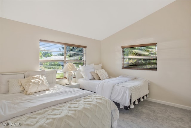 bedroom featuring light carpet and lofted ceiling