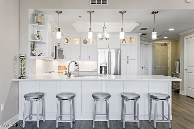 kitchen featuring a peninsula, open shelves, stainless steel appliances, glass insert cabinets, and white cabinetry