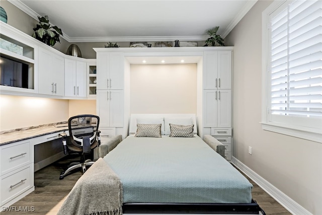 bedroom with dark wood-style floors, built in study area, crown molding, and baseboards