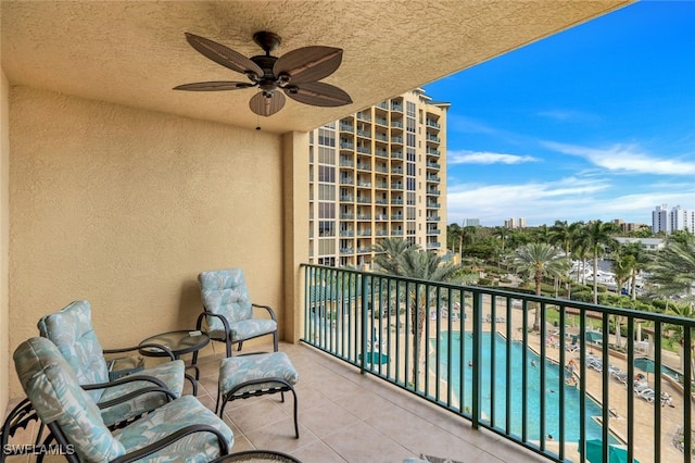 balcony featuring a city view and ceiling fan