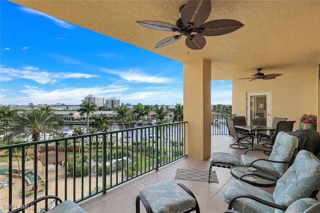 balcony with a view of city and ceiling fan