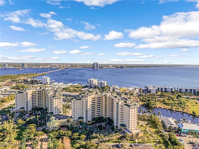 birds eye view of property featuring a water view and a view of city