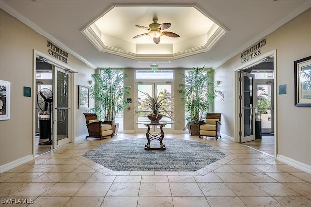 unfurnished room with a ceiling fan, a raised ceiling, french doors, and baseboards