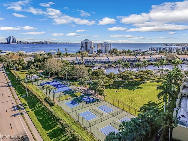 drone / aerial view featuring a city view and a water view