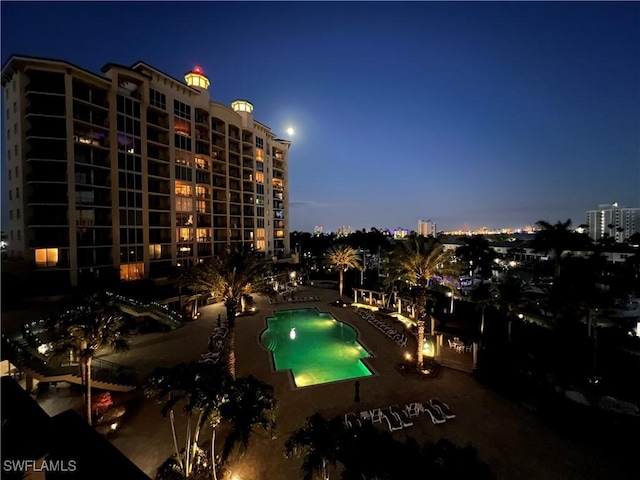 community pool with a city view and a patio area