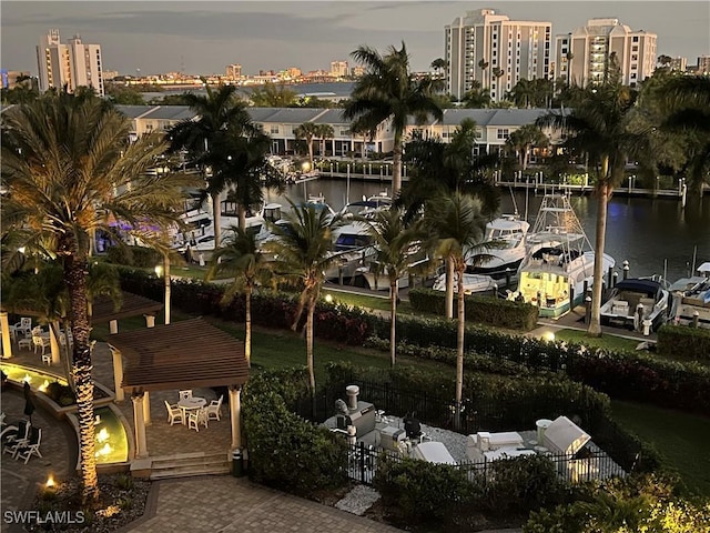 exterior space featuring a city view, fence, and a dock