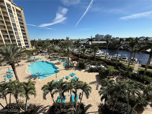 view of swimming pool with a patio and a water view