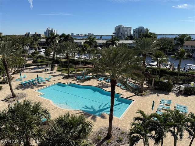 community pool with a view of city and a patio area