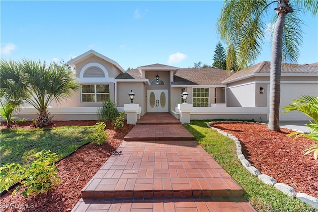 single story home with a garage and french doors