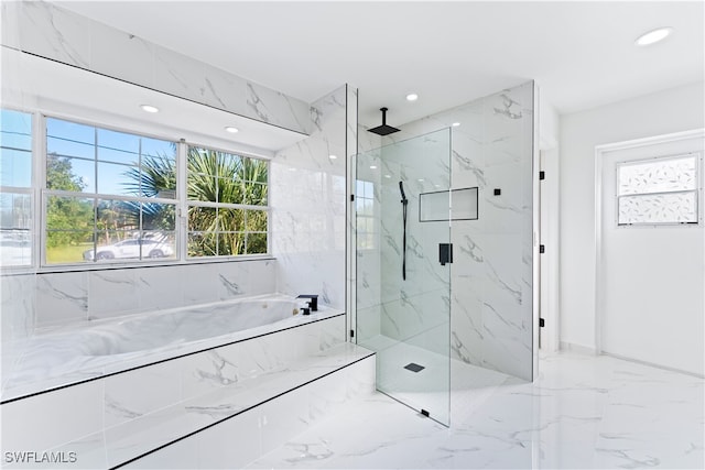 bathroom featuring separate shower and tub