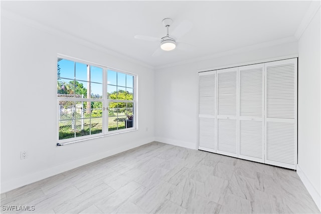 unfurnished bedroom featuring ornamental molding, a closet, and ceiling fan