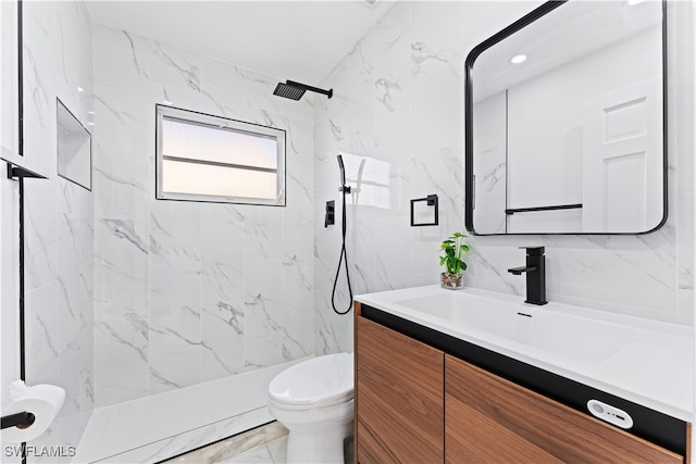 bathroom featuring vanity, toilet, and tiled shower