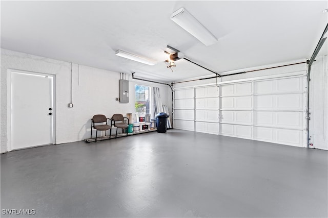 garage with a garage door opener and electric panel