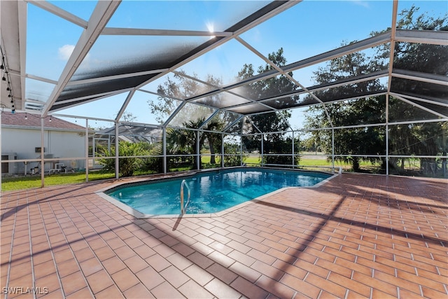 view of pool featuring a lanai and a patio